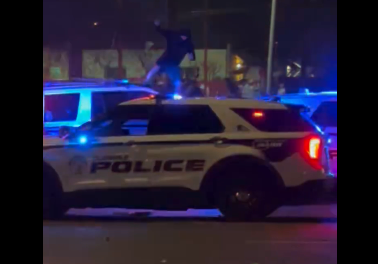 Protestor jumps on top of police vehicle in Phoenix 