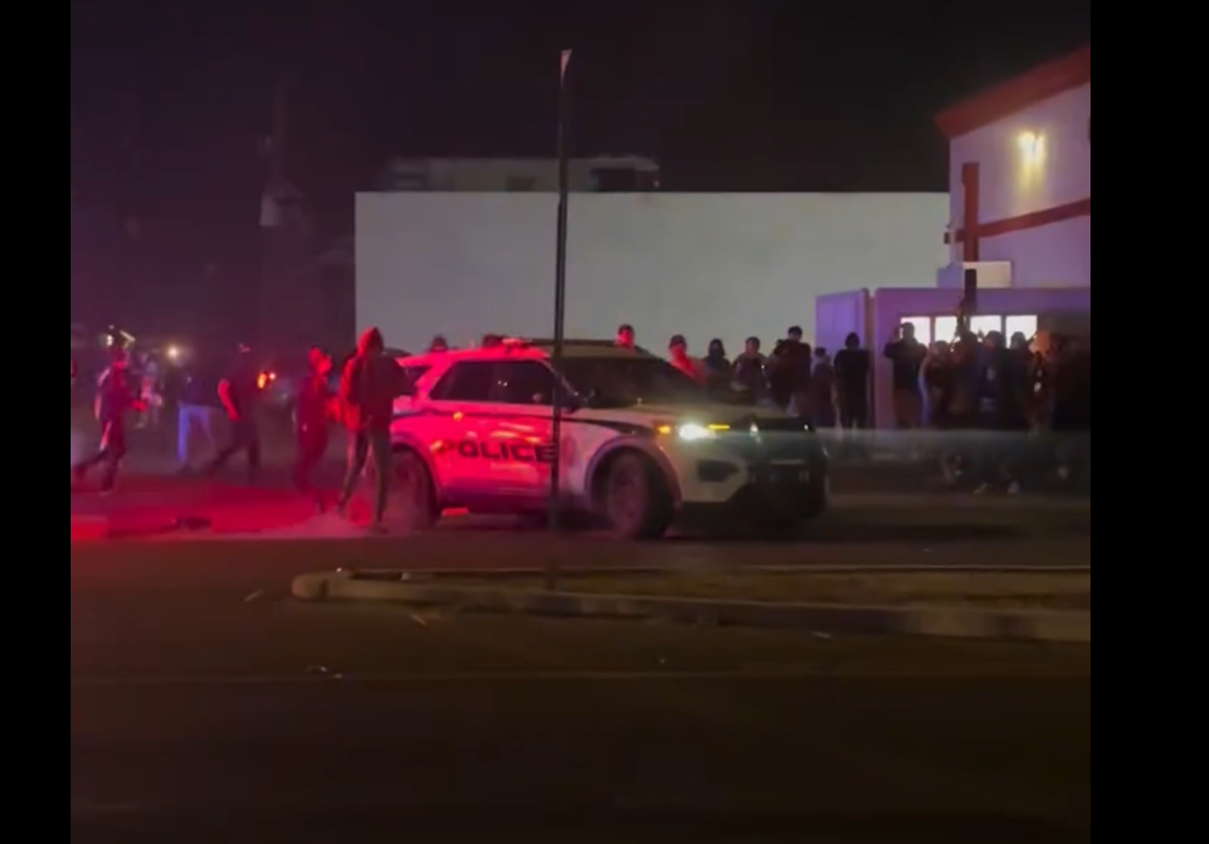 Protestor driving away in Phoenix patrol vehicle